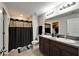 Bathroom featuring double sinks and a shower with a black shower curtain at 10119 Rose Petal Pl, Riverview, FL 33578
