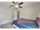 This bedroom features a ceiling fan, closet and doorway leading to the rest of the house at 10119 Rose Petal Pl, Riverview, FL 33578