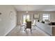 Open dining area with modern table set, stylish chandelier, and cozy couch at 10119 Rose Petal Pl, Riverview, FL 33578