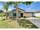 Single-story home with a two-car garage, blue exterior paint, and neat landscaping at 10119 Rose Petal Pl, Riverview, FL 33578
