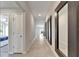 Long tiled hallway leading to rooms and featuring decorative mirrors on the wall at 10119 Rose Petal Pl, Riverview, FL 33578
