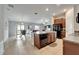 Open kitchen with island, black appliances, and seamless flow to the living and dining areas at 10119 Rose Petal Pl, Riverview, FL 33578