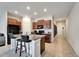 Kitchen featuring a breakfast bar, brown cabinets, and black appliances at 10119 Rose Petal Pl, Riverview, FL 33578