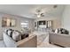 Cozy living room featuring tile flooring, plush seating, and a decorative mirror at 10119 Rose Petal Pl, Riverview, FL 33578