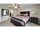 A well-lit main bedroom with a ceiling fan and an ensuite bathroom at 10119 Rose Petal Pl, Riverview, FL 33578
