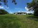 Spacious backyard with well-maintained lawn and partial view of the back of the home at 1106 Trellis Ave, Spring Hill, FL 34606