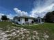 Lush yard with an enclosed lanai, perfect for outdoor entertaining and enjoying the scenery at 1106 Trellis Ave, Spring Hill, FL 34606