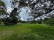 Scenic backyard with pond surrounded by trees, offering a serene and private setting at 1106 Trellis Ave, Spring Hill, FL 34606