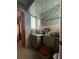Bathroom featuring light green sink vanity, linoleum floors and floral wallpaper at 1106 Trellis Ave, Spring Hill, FL 34606