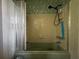 Bathroom featuring tub/shower combo with shower curtain and tiled walls at 1106 Trellis Ave, Spring Hill, FL 34606