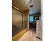 View of bathroom featuring shower with gold frame and patterned walls at 1106 Trellis Ave, Spring Hill, FL 34606