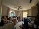 Cluttered bedroom with vanity, ceiling fan, and patterned walls and floors at 1106 Trellis Ave, Spring Hill, FL 34606