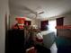Cluttered bedroom with a ceiling fan and stacked boxes and furniture at 1106 Trellis Ave, Spring Hill, FL 34606