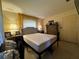 Bedroom featuring dresser, nightstand, bed, and two windows for natural light at 1106 Trellis Ave, Spring Hill, FL 34606
