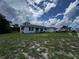 Quaint home featuring a driveway, single-car garage, and a lawn needing some TLC at 1106 Trellis Ave, Spring Hill, FL 34606