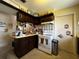 Cozy kitchen with dark cabinets and white appliances at 1106 Trellis Ave, Spring Hill, FL 34606
