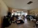 Spacious living room with an attached, enclosed patio and lots of natural light at 1106 Trellis Ave, Spring Hill, FL 34606