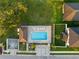 Overhead view of a swimming pool and adjacent community, and home backyards at 11597 Weaver Hollow Rd, New Port Richey, FL 34654