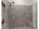 Beautiful bathroom shower featuring a rainfall shower head, built in soap storage, and neutral tile at 11597 Weaver Hollow Rd, New Port Richey, FL 34654