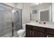 Stylish bathroom featuring a glass-enclosed shower, modern vanity, and contemporary fixtures at 11597 Weaver Hollow Rd, New Port Richey, FL 34654