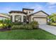 Charming single-Gathering home featuring a well-manicured lawn and attached two-car garage at 11597 Weaver Hollow Rd, New Port Richey, FL 34654