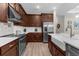 Well-equipped kitchen boasts a farmhouse sink, stainless steel appliances, and ample countertop space at 11597 Weaver Hollow Rd, New Port Richey, FL 34654