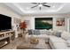 Cozy living room with large sectional sofa, fireplace, ceiling fan, and a view of the backyard at 11597 Weaver Hollow Rd, New Port Richey, FL 34654