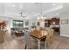 Spacious living room with lake views, open to dining and kitchen, with wood floors and modern decor at 11597 Weaver Hollow Rd, New Port Richey, FL 34654