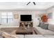 Inviting living room featuring a large sectional sofa, media center with fireplace, and wood flooring at 11597 Weaver Hollow Rd, New Port Richey, FL 34654