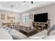 Bright living room with a dining area, media center with fireplace, and wood flooring at 11597 Weaver Hollow Rd, New Port Richey, FL 34654