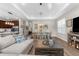 Open-concept living room and dining area with a kitchen view, wood floors and recessed lighting at 11597 Weaver Hollow Rd, New Port Richey, FL 34654