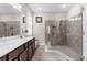 Bathroom featuring a double vanity with granite countertop and a glass walk-in shower at 11597 Weaver Hollow Rd, New Port Richey, FL 34654