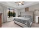 Spacious main bedroom with a trey ceiling, large window, king bed and carpet floors at 11597 Weaver Hollow Rd, New Port Richey, FL 34654