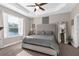 Bright main bedroom featuring a king bed, tray ceiling, large window and carpet floors at 11597 Weaver Hollow Rd, New Port Richey, FL 34654