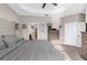 Carpeted main bedroom featuring a king bed, trey ceiling, a walk-in closet and modern decor at 11597 Weaver Hollow Rd, New Port Richey, FL 34654