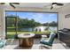 Screened-in patio with outdoor seating and a serene view of the lake and trees, perfect for relaxing at 11597 Weaver Hollow Rd, New Port Richey, FL 34654