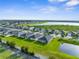 Residential area featuring single-Gathering homes with lush lawns, a pond, and scenic surroundings at 11940 Stone Pine St, Riverview, FL 33569