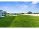 Large backyard with a scenic pond view and a white privacy fence at 11940 Stone Pine St, Riverview, FL 33569