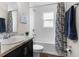 Clean bathroom with a shower-tub combo, updated vanity, and stylish fixtures at 11940 Stone Pine St, Riverview, FL 33569