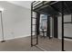 Bedroom featuring a large window, neutral walls, and a sleek metal bunk bed frame at 11940 Stone Pine St, Riverview, FL 33569