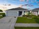 Charming single-story home with a manicured lawn, two car garage, and cozy front porch at 11940 Stone Pine St, Riverview, FL 33569