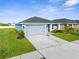 Charming single-story home with a well-manicured lawn and a two-car garage at 11940 Stone Pine St, Riverview, FL 33569
