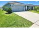 Charming single-story home with a well manicured front yard and concrete driveway at 11940 Stone Pine St, Riverview, FL 33569