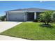 Charming single-story home featuring a well-maintained lawn, a two-car garage, and tidy landscaping at 11940 Stone Pine St, Riverview, FL 33569