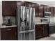 Modern kitchen featuring stainless steel appliances, dark cabinetry, and light countertops at 11940 Stone Pine St, Riverview, FL 33569