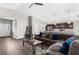 Inviting living room open to the kitchen with abundant seating, lighting, and wood-look flooring at 11940 Stone Pine St, Riverview, FL 33569