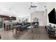 Open-concept living room with vaulted ceiling, hardwood floors, and seamlessly connected to the kitchen area at 11940 Stone Pine St, Riverview, FL 33569