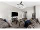 Living room area features ceiling fan, vaulted ceilings, and a neutral color palette at 11940 Stone Pine St, Riverview, FL 33569