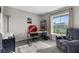 Bright home office featuring a large window, neutral walls, and a comfortable gray armchair at 11940 Stone Pine St, Riverview, FL 33569