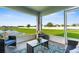 Screened patio overlooking lush green space and a pond, featuring comfortable seating at 11940 Stone Pine St, Riverview, FL 33569